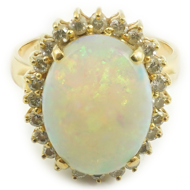 An 18k gold, white opal and diamond set oval cluster ring